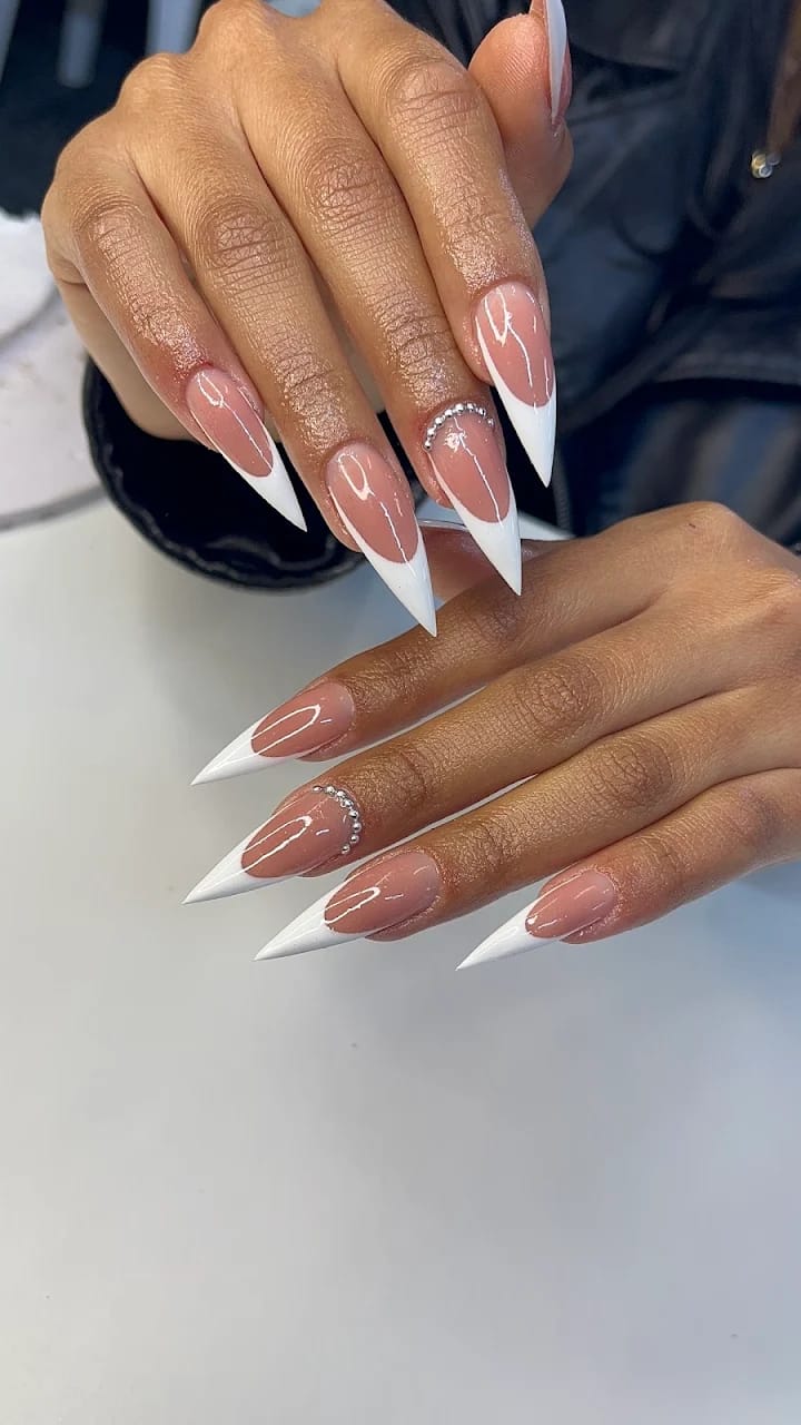 Long stiletto nails with white French tips and crystal detail