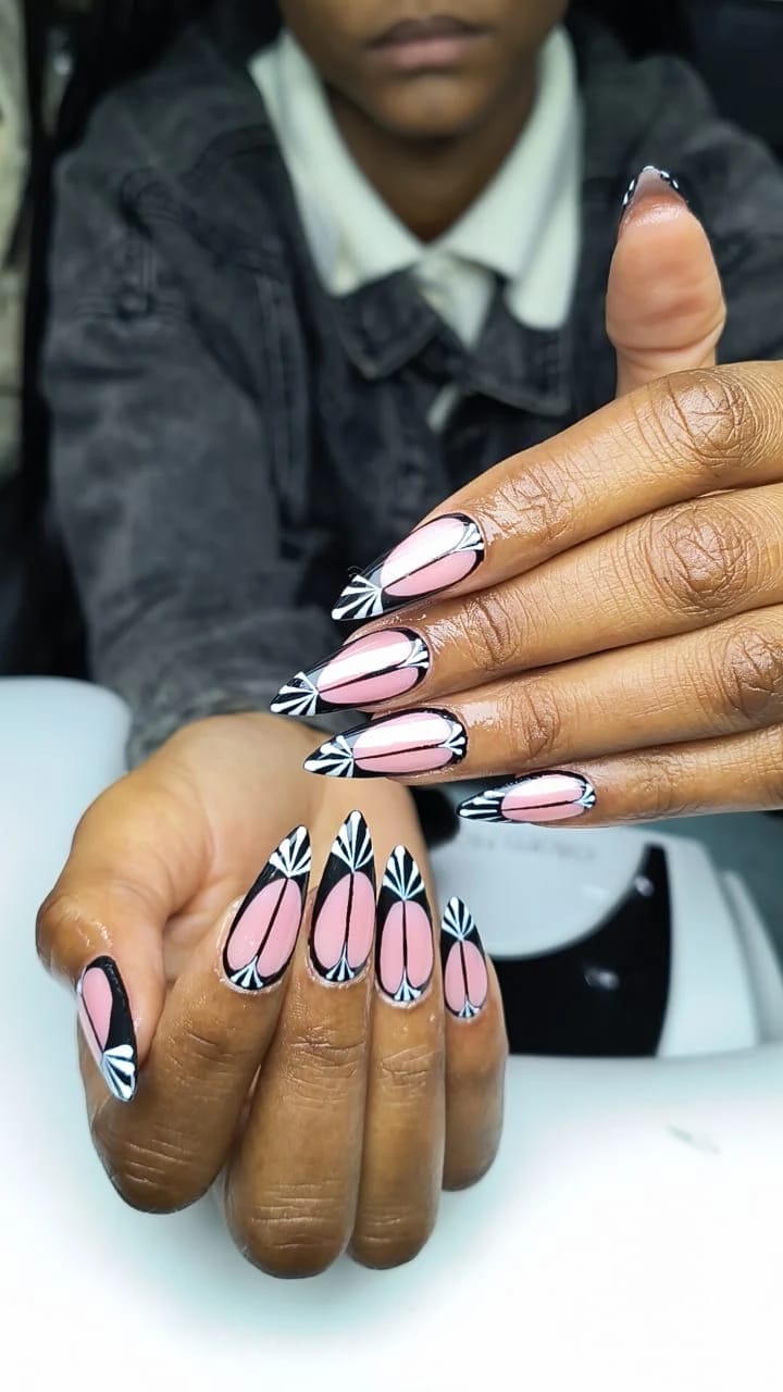 Pink and black art-deco fan nail art on almond nails